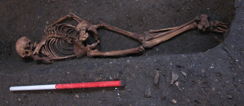 Context 958 was found buried face-down in the historic cemetery of St John’s. (Image credit: C. Cessford)